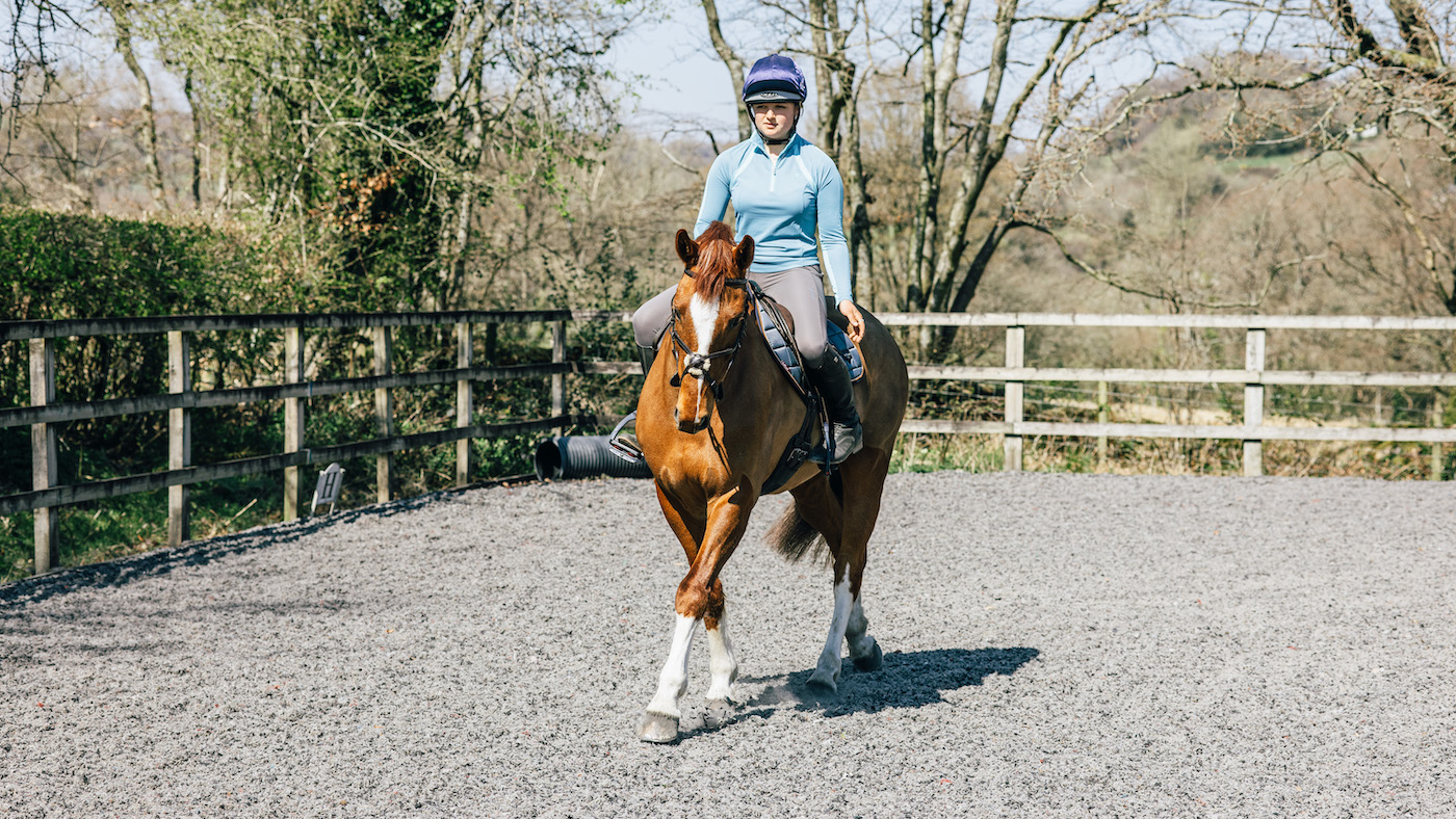Building confidence to ride alone. Working through an exercise on chestnut horse