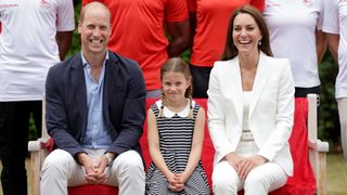 Prince William, Duke of Cambridge, Catherine, Duchess of Cambridge and Princess Charlotte of Cambridge pose for a photograph as they visit Sportsid House