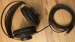 AKG K72 headphones on a wooden surface