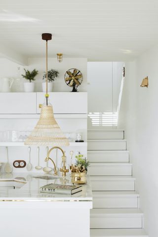 white coastal kitchen with steps and pendant light