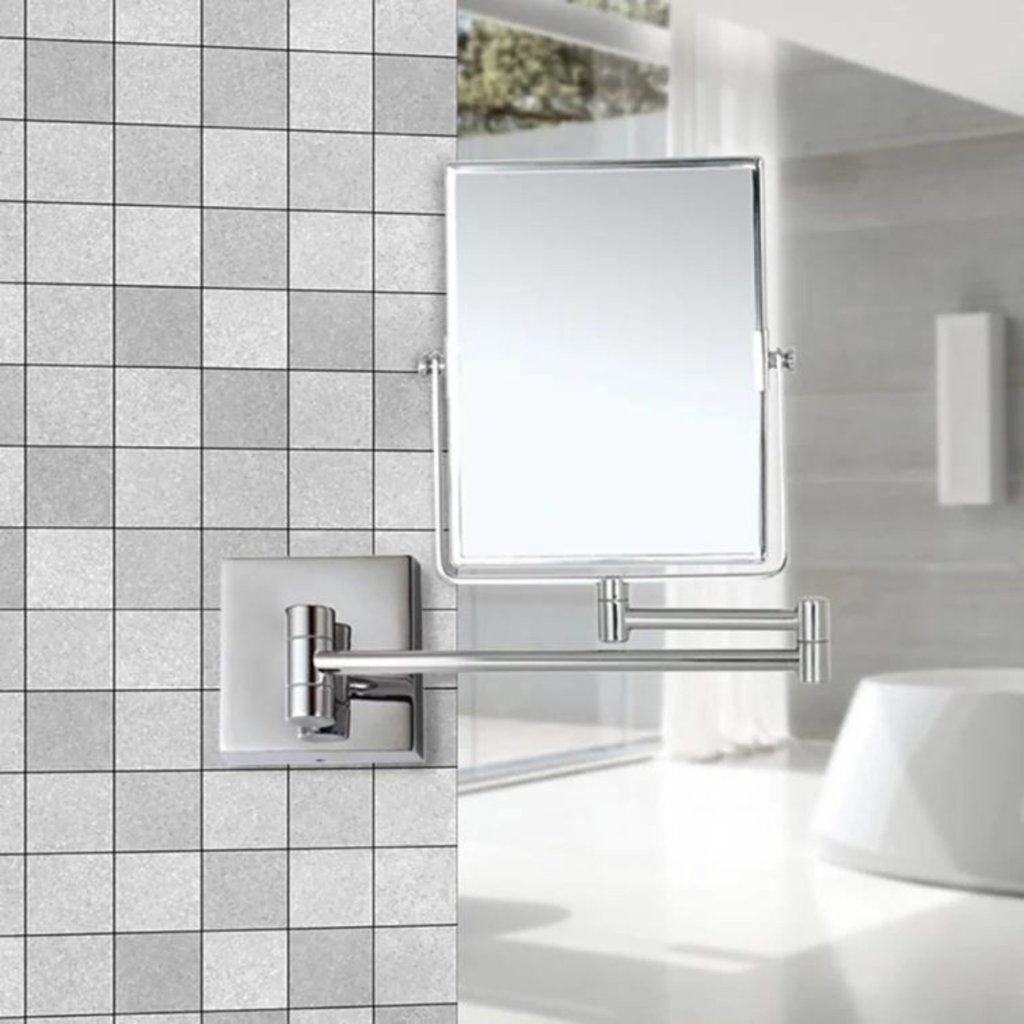 A rectangular vanity mirror mounted to a bathroom wall