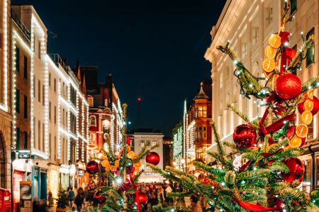 Christmas trees and Christmas lights in London high street.