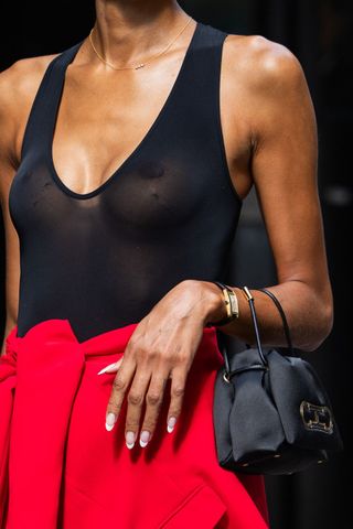 Close up of woman's hands with french manicure, a key New York Fashion Week street style beauty trend