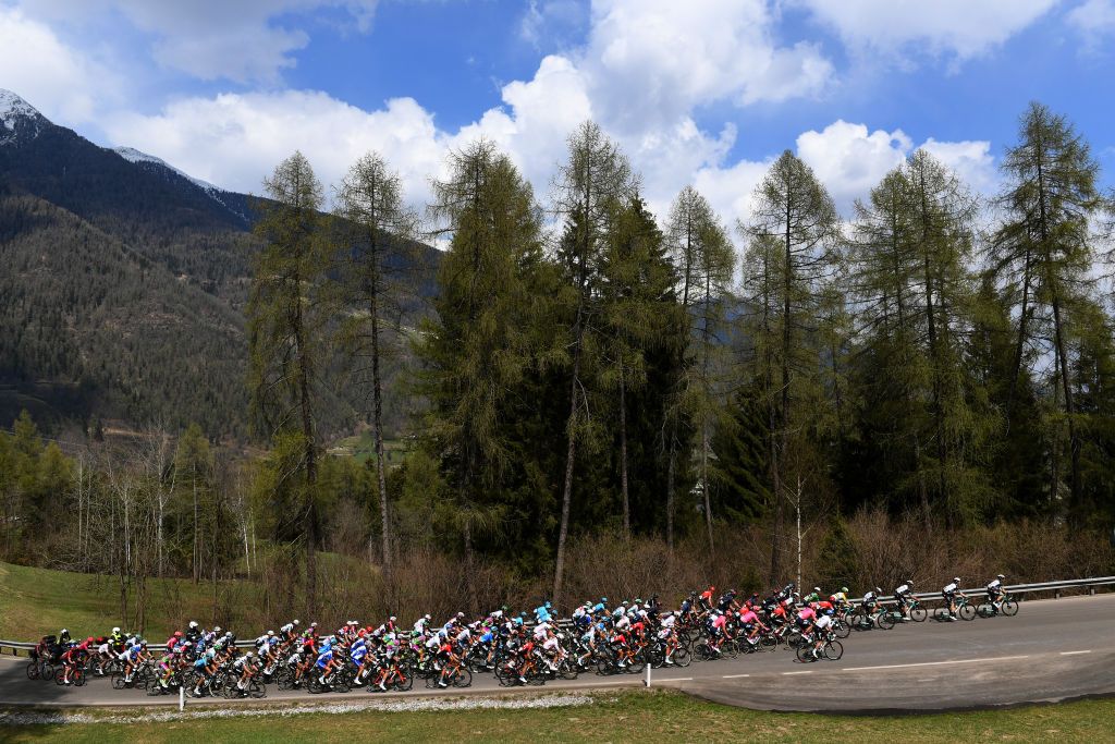 PIEVEDIBONO ITALY APRIL 22 The peloton passing through Dimaro 766m landscape during the 44th Tour of the Alps 2021 Stage 4 a 1686 to stage from Naturns to Valle del Chiese Pieve di Bono TourofTheAlps Mountains Snow Forest TouroftheAlps on April 22 2021 in Pieve di Bono Italy Photo by Tim de WaeleGetty Images