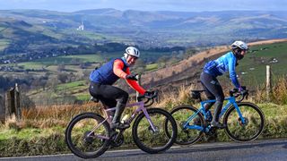 Two cyclists ride in the UK in cold weather