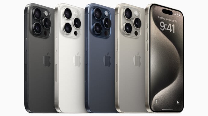 The four iPhone 15 color options stcaked next to each other. We see black, white, blue and natural titanium finishes.