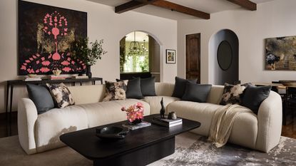 large living room with large cream sofa and black coffee table