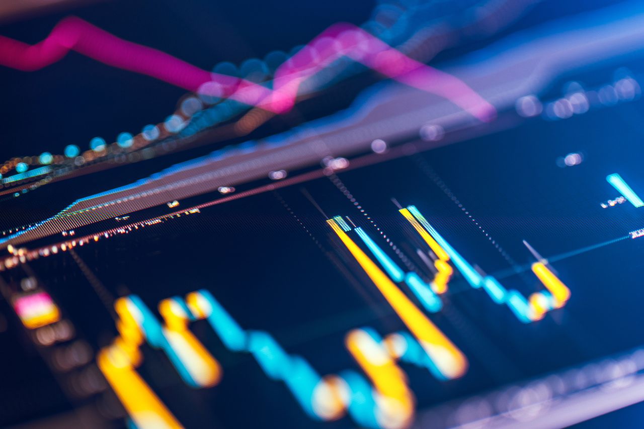 closeup of financial chart with yellow and teal bars and bright pink moving average