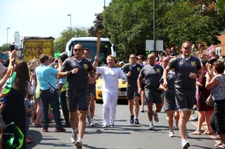 Rupert Grint carrying the Olympic Torch in 2012.