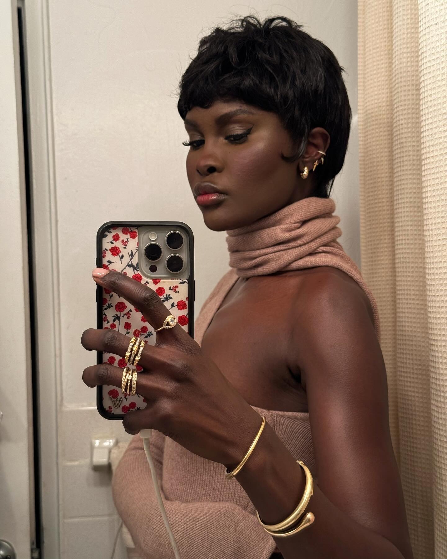 A woman taking a mirror selfie with a tuft bob hairstyle