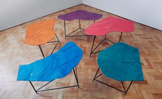 Five tables with different coloured and different shaped tops