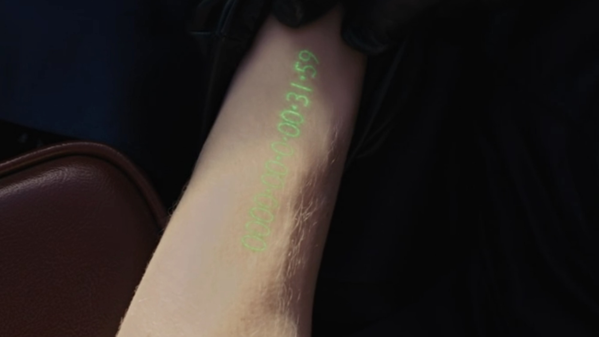 An arm with a digital clock on it in In Time