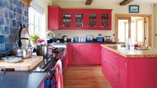 Bold red painted kitchen by Parlour Farm