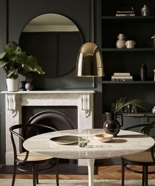 Black and marble dining area with pendant light by Original BTC