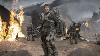 Tom Cruise as Major William Cage standing in a battlefield during the alien movie, Edge of Tomorrow.