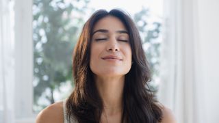 Sleep hygiene: image shows woman breathing for relaxation