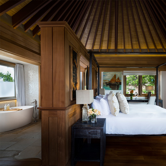 bedroom with table lamp and bed with pillows