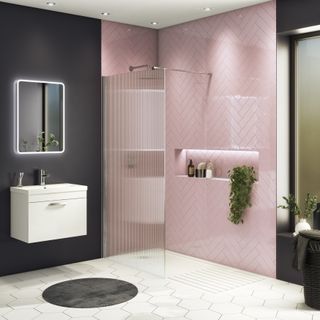 shower room with pink tiles, black walls and a fluted shower screen