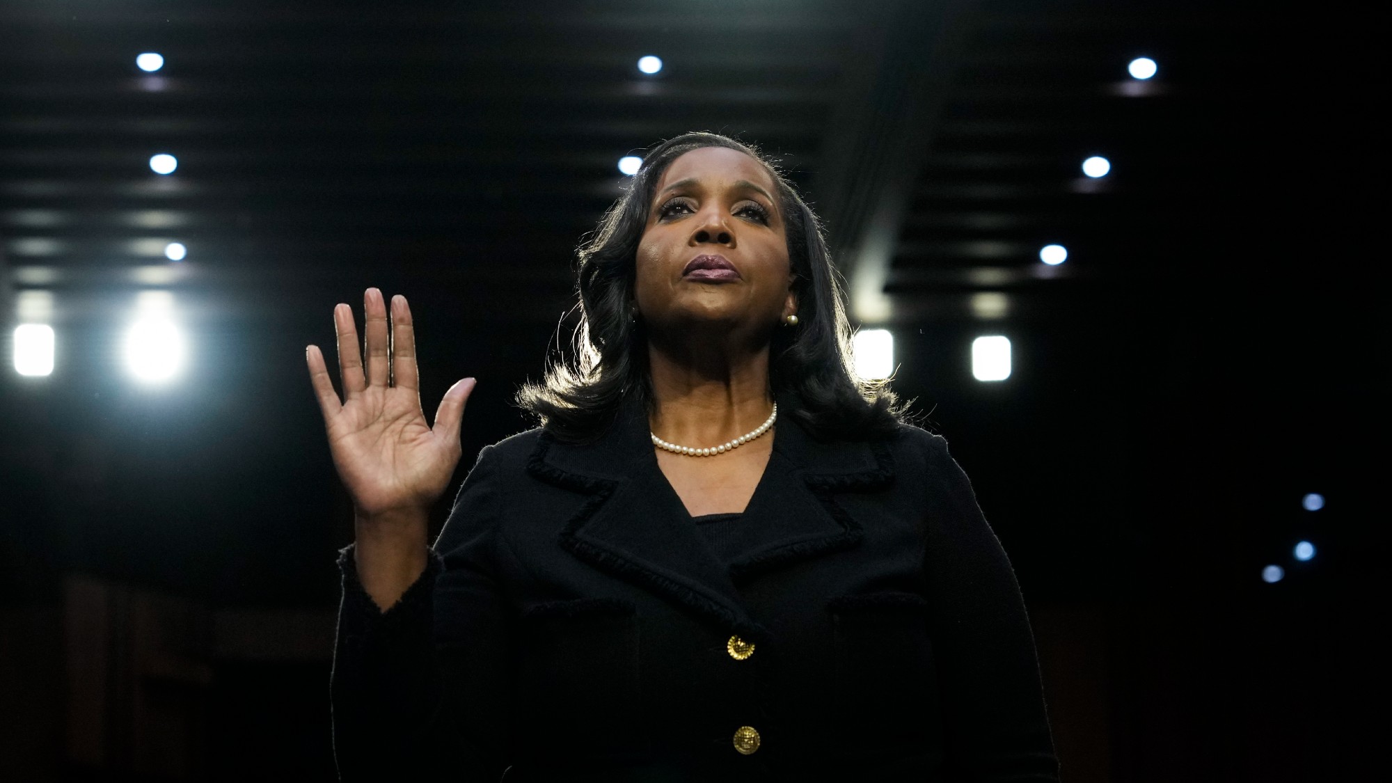 Lisa Cook raises her hand as she is sworn in at a Senate Banking nominations hearing in June 2023 