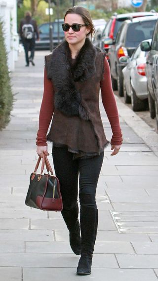 Pippa Middleton walks in London wearing jeans, a red jumper, gilet and knee high boots January 06, 2012