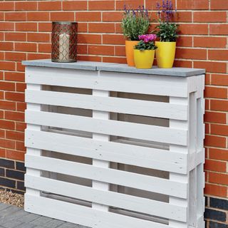 White pallets upcylced into shelf stand for garden