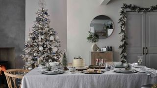 snowy Christmas tree theme in an all grey dining area that feels elegantly understated