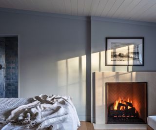 Bedroom with burning fireplace