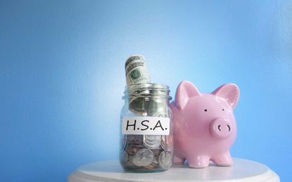 Concept art of a piggy bank with HSA written on it next to a jar of money