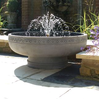 traditional centrepece water fountain with plants