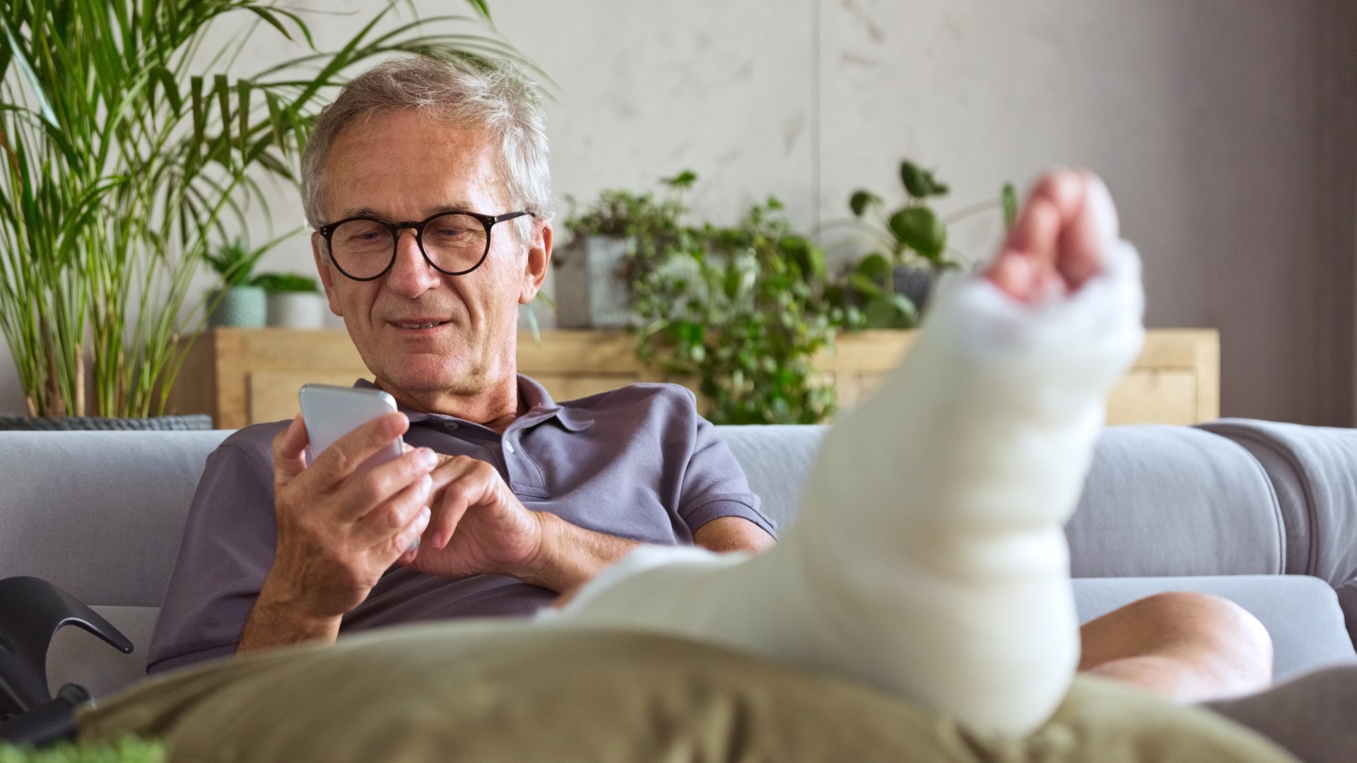 An elderly man with a broken leg at home