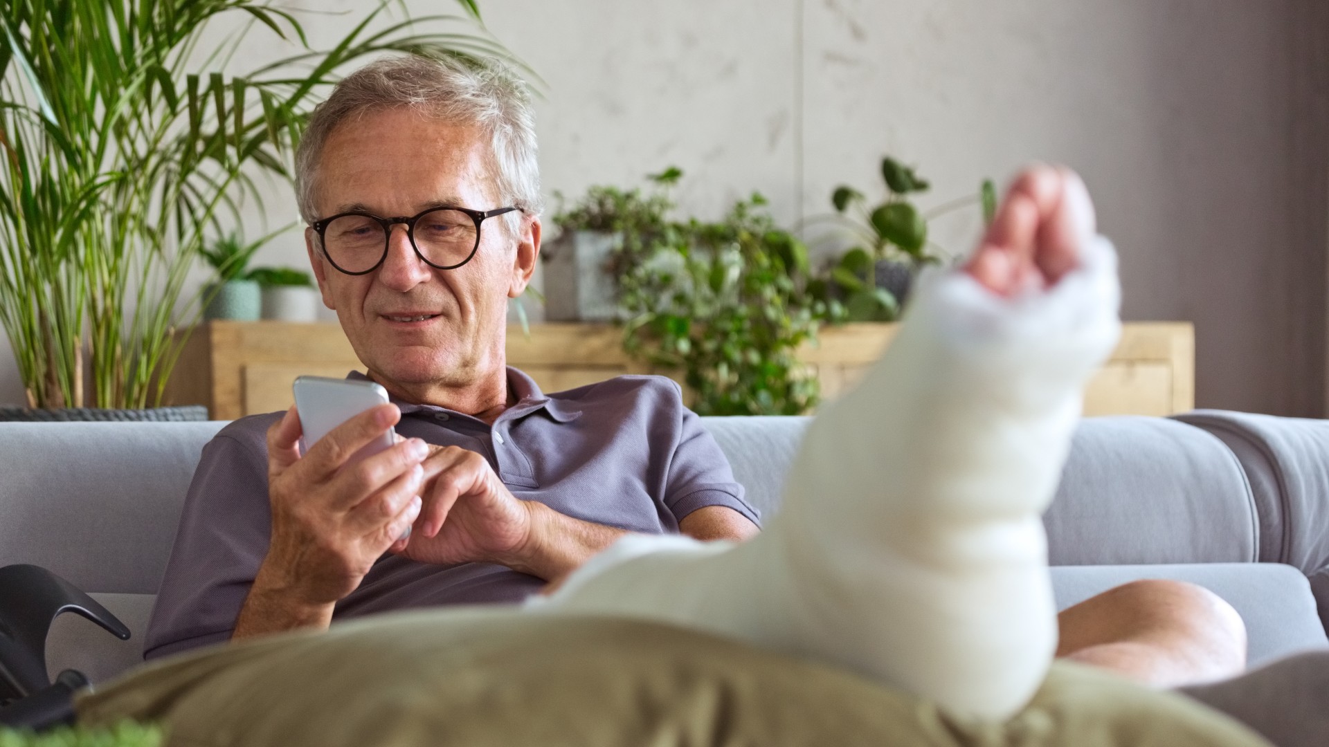 Senior man with broken leg at home