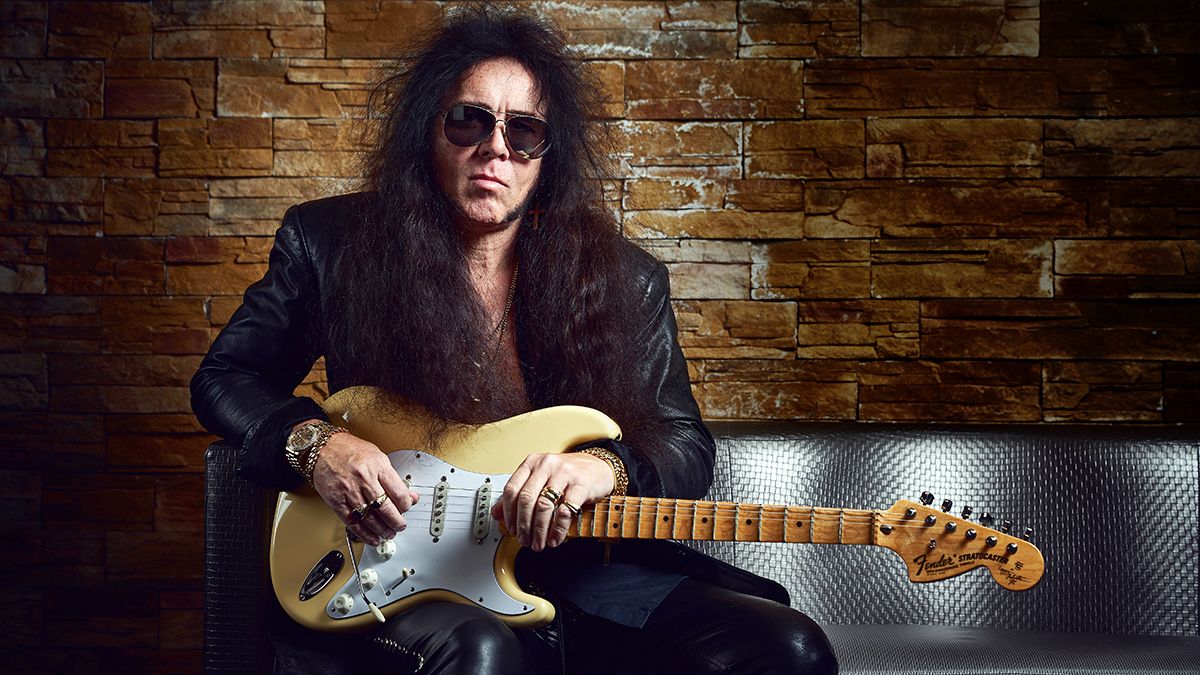 Yngwie Malmsteen holding his Fender signature Stratocaster