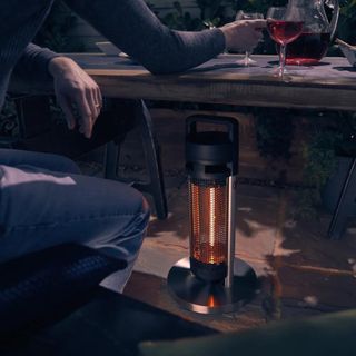 picture of Swan patio heater under a table in the dark