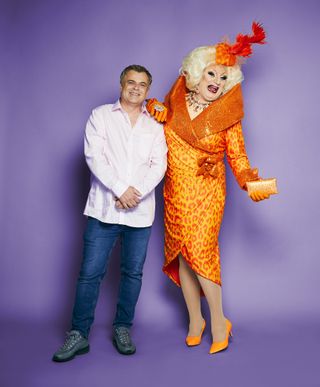 Simon Gregson in a posed shot - in his everyday clothes - next to his drag mentor Myra DuBois, who is in full drag