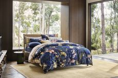 a dark blue patterned bedset on a bed
