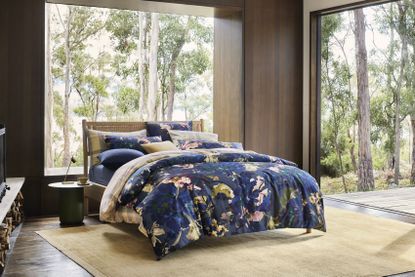 a dark blue patterned bedset on a bed