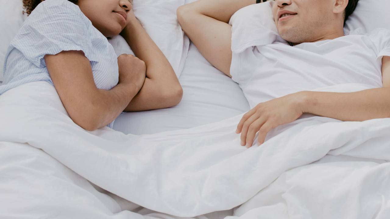 Couple sleeping under a duvet