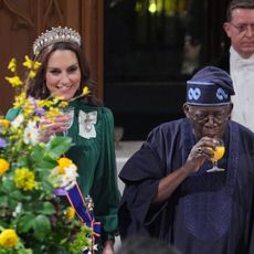 Kate Middleton, King Charles and the president of Nigeria toasting at a banquet