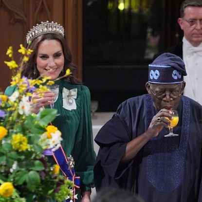 Kate Middleton, King Charles and the president of Nigeria toasting at a banquet