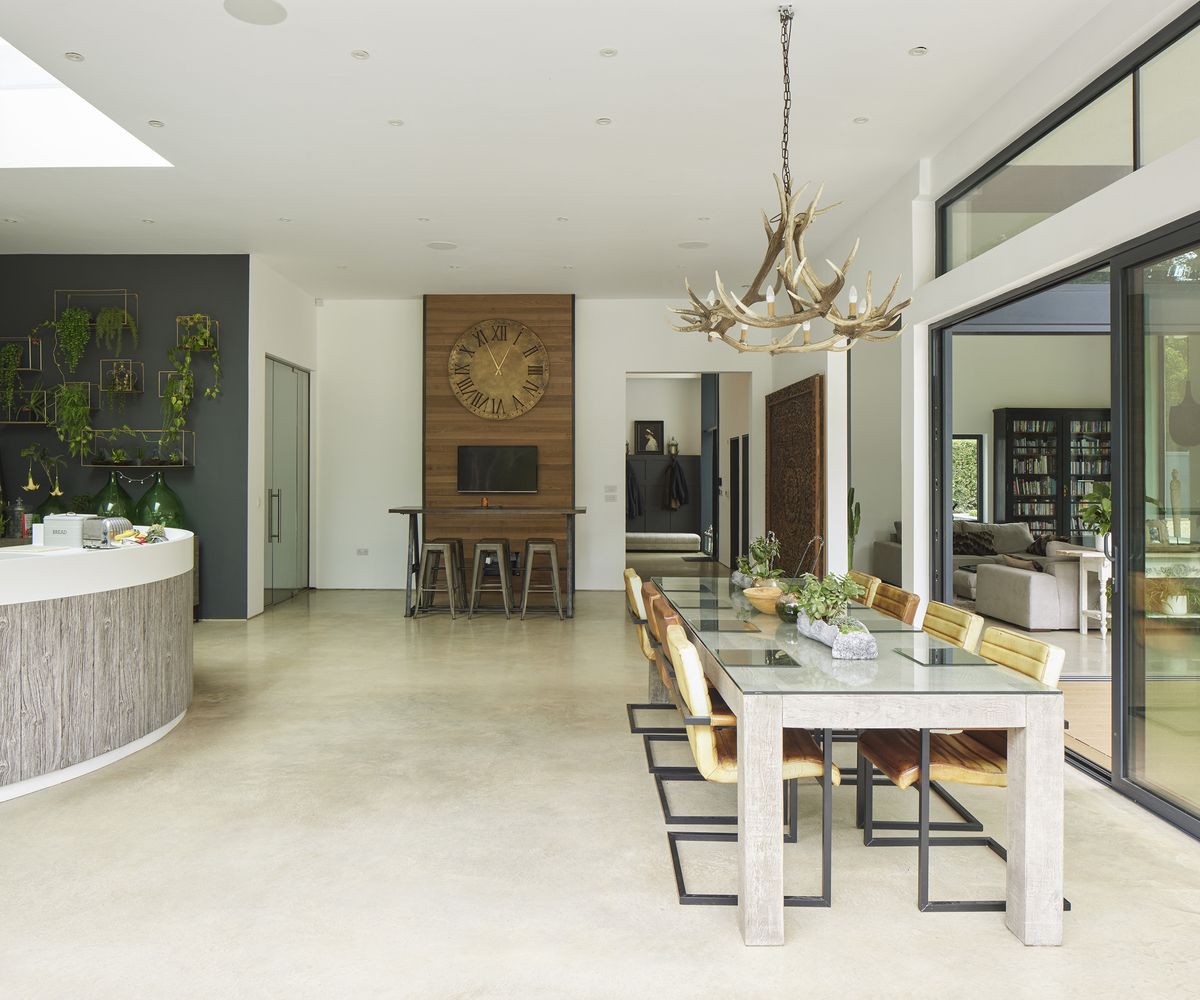open plan kitchen and dining room with hanging statement light pendant