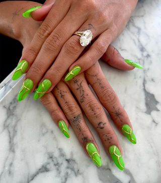 Green, glow-in-the-dark manicure for Hailey Bieber by Zola Ganzorigt.