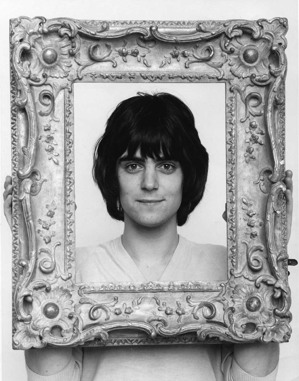 Terry Reid holding a picture frame in front of him