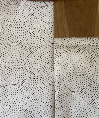 Two panels of spotted white and black wallpaper laid parallel to each other