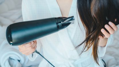 TikTok blow dry hack - woman blow drying hair