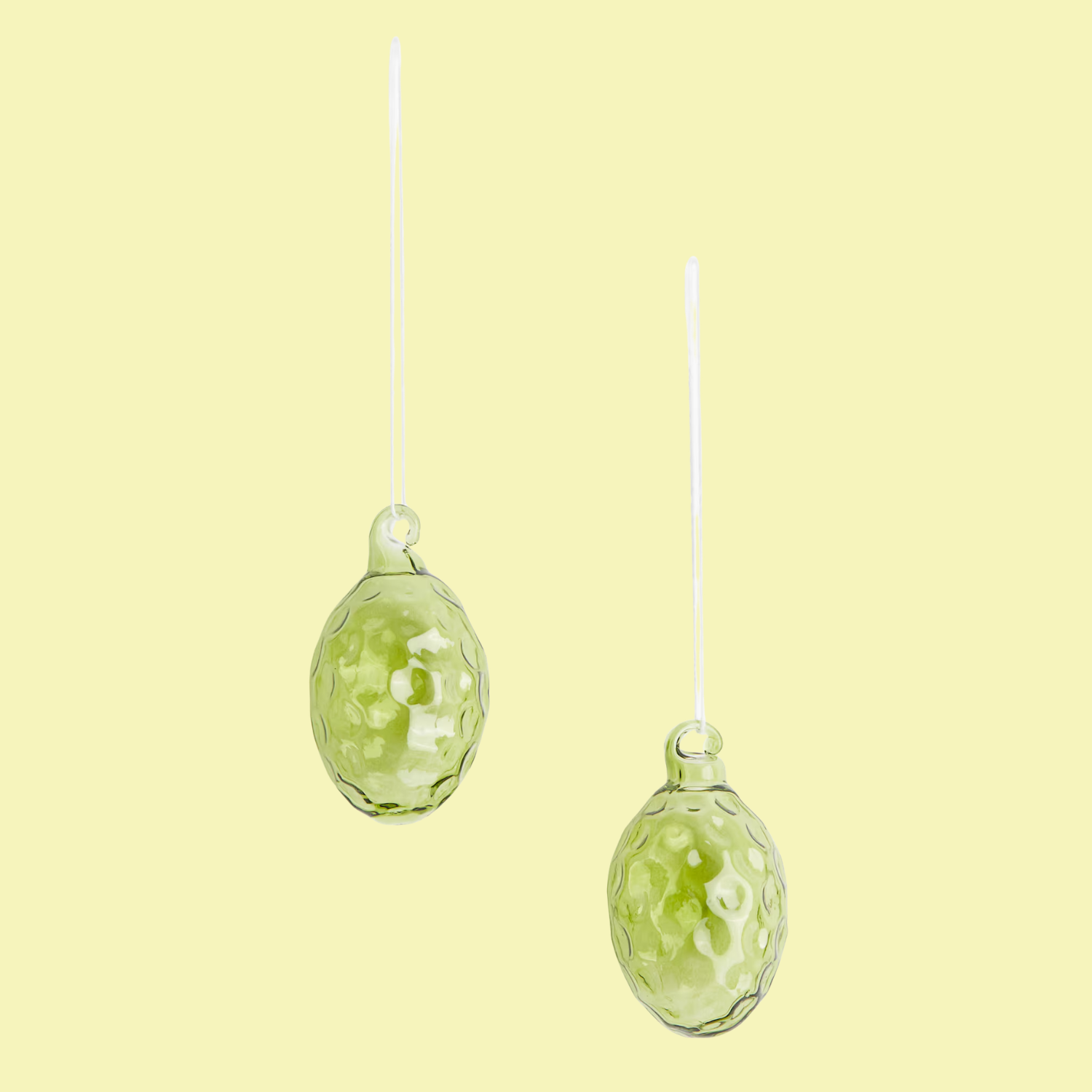 A set of two green glass ornaments