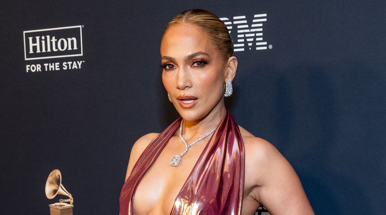 Jennifer Lopez wears shimmering, backless, plunging dress with Harry Kotlar cushion-cut diamond drop necklace