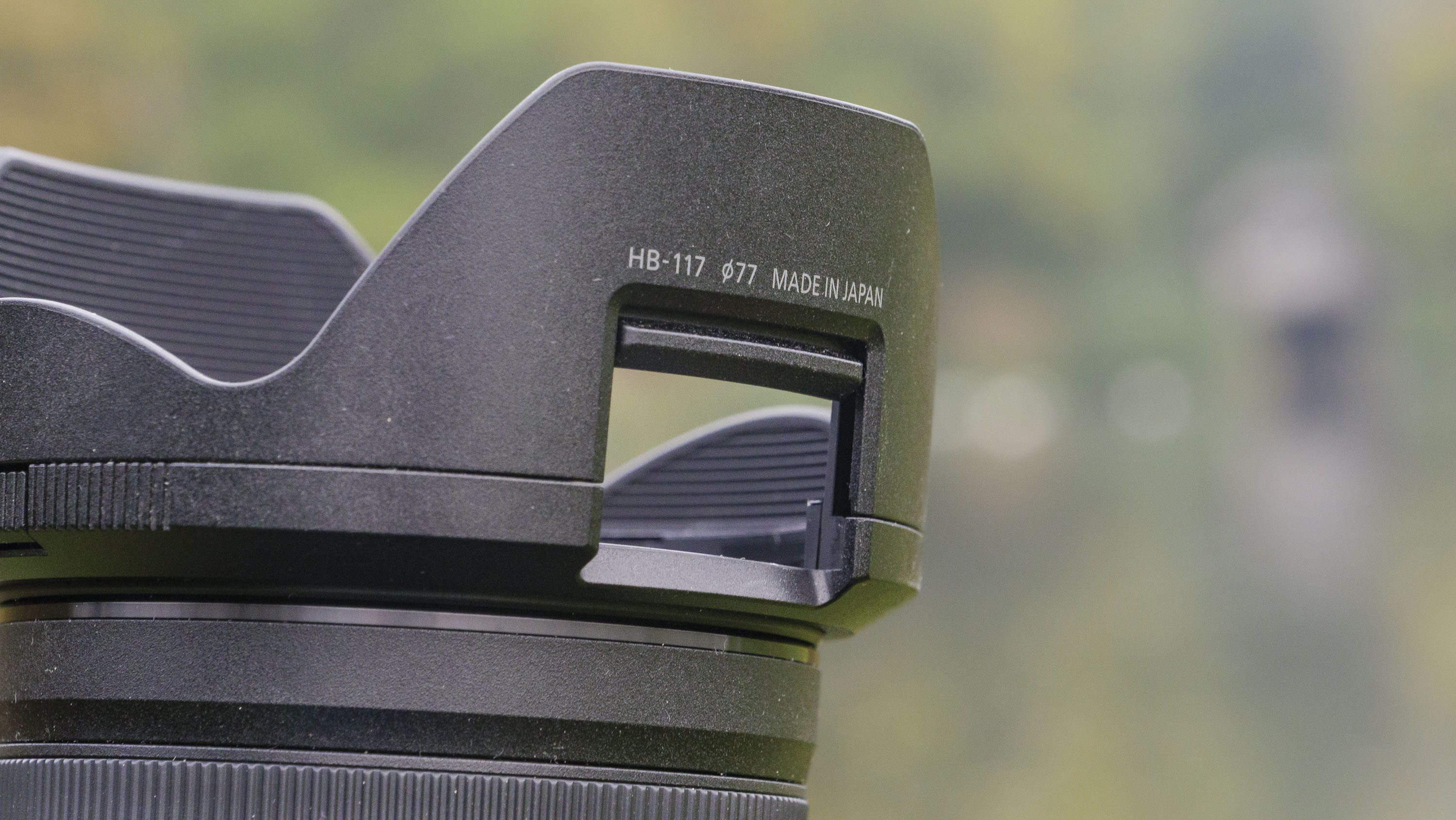Closeup of the Nikon Z 24-70mm f/2.8 S II lens' lens hood with filter hatch closeed