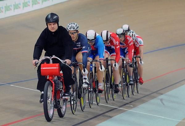 Riders are lined up behind the derny for the men's keirin championship race.
