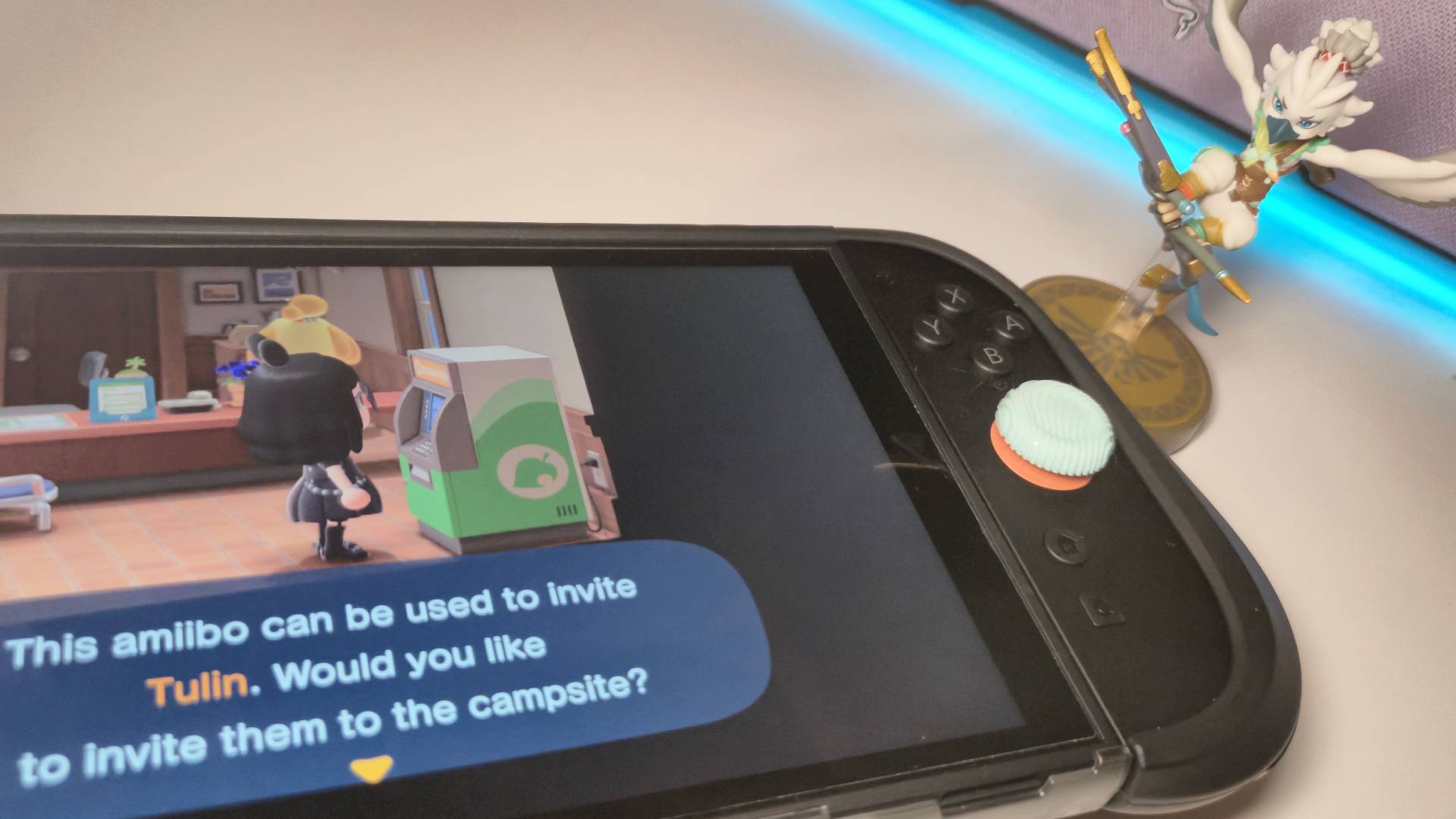 Photo of a Switch 2 running Animal Crossing New Horizons with the Tulin amiibo sitting next to it.