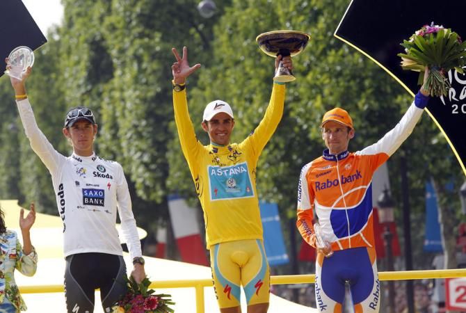 Denis Menchov, right, on the 2010 final Tour de France podium with Andy Schleck, left, and Alberto Contador. After Contador was stripped of his title due to doping, Menchov would move up to 2nd overall on GC.